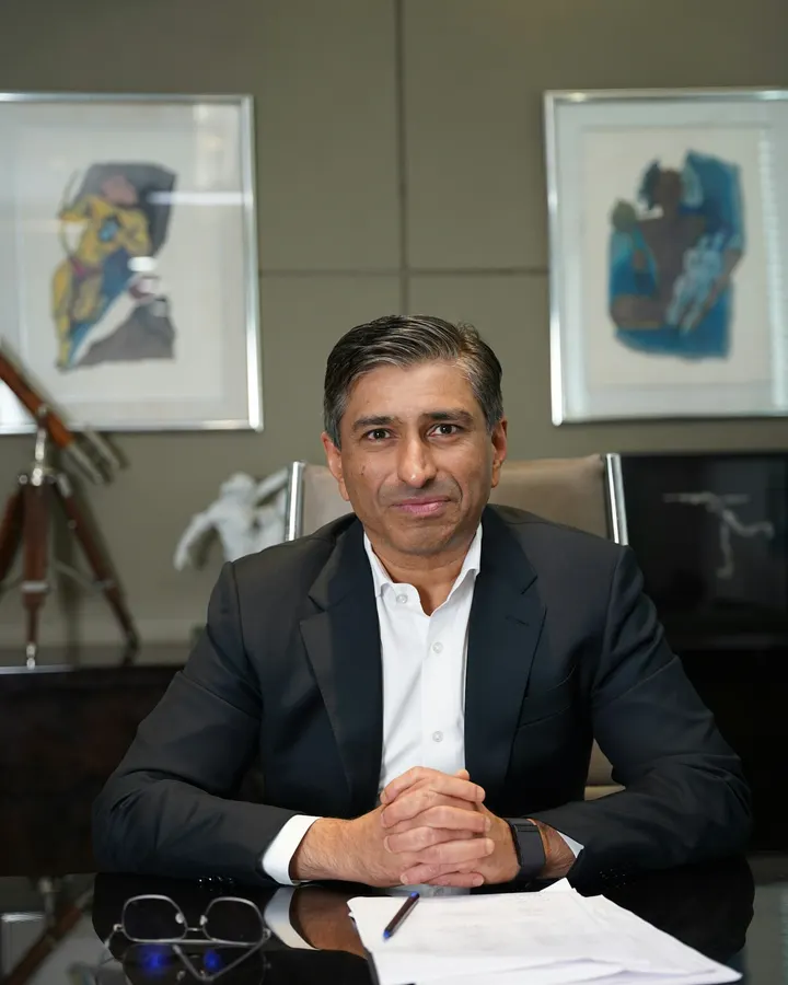 A senior advocate seated at his desk with papers